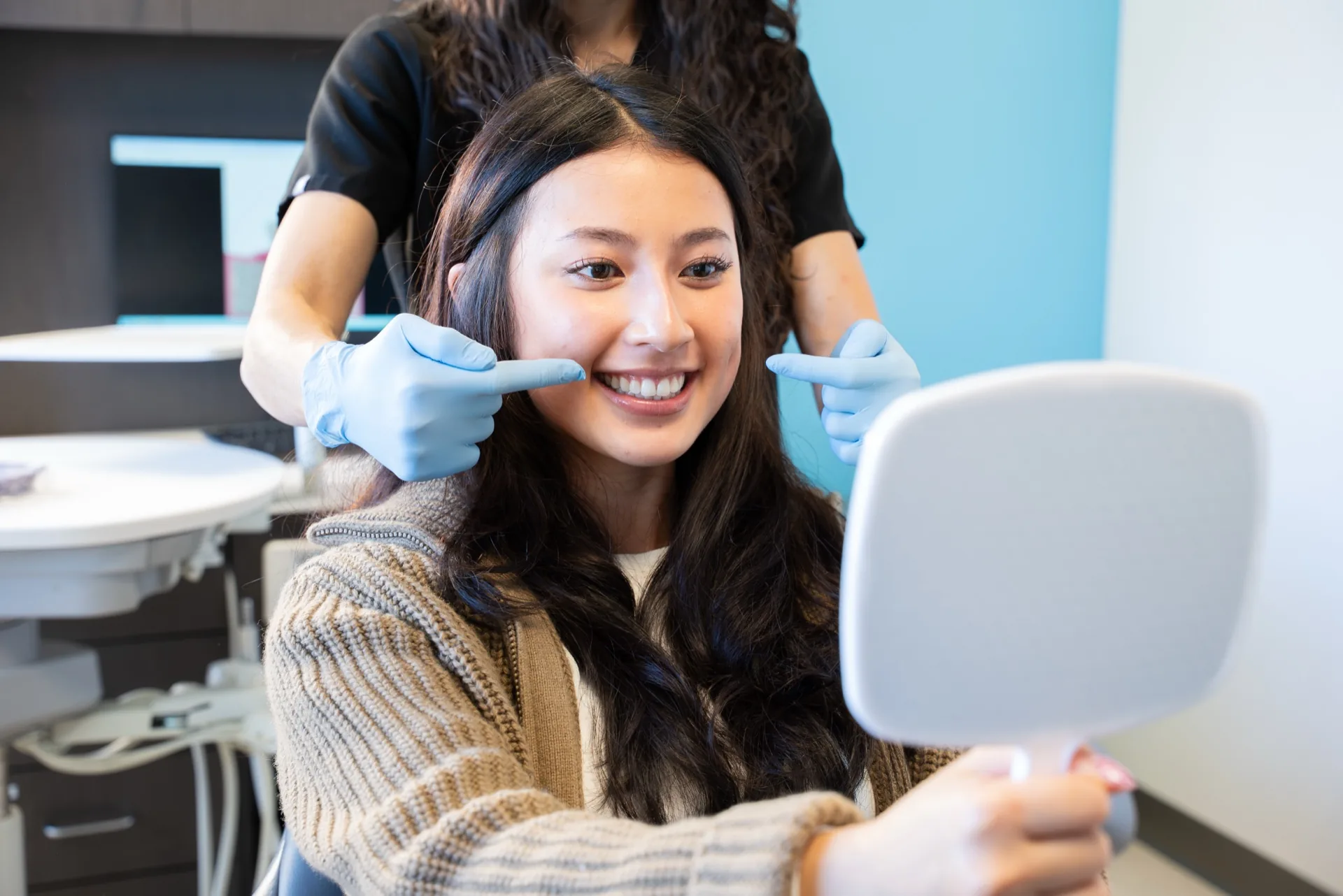 Patient smiling after professional teeth whitening at Oasis Dental