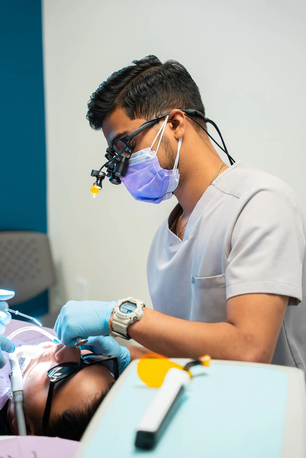 Oasis Dental clinician using surgical loupes during a procedure