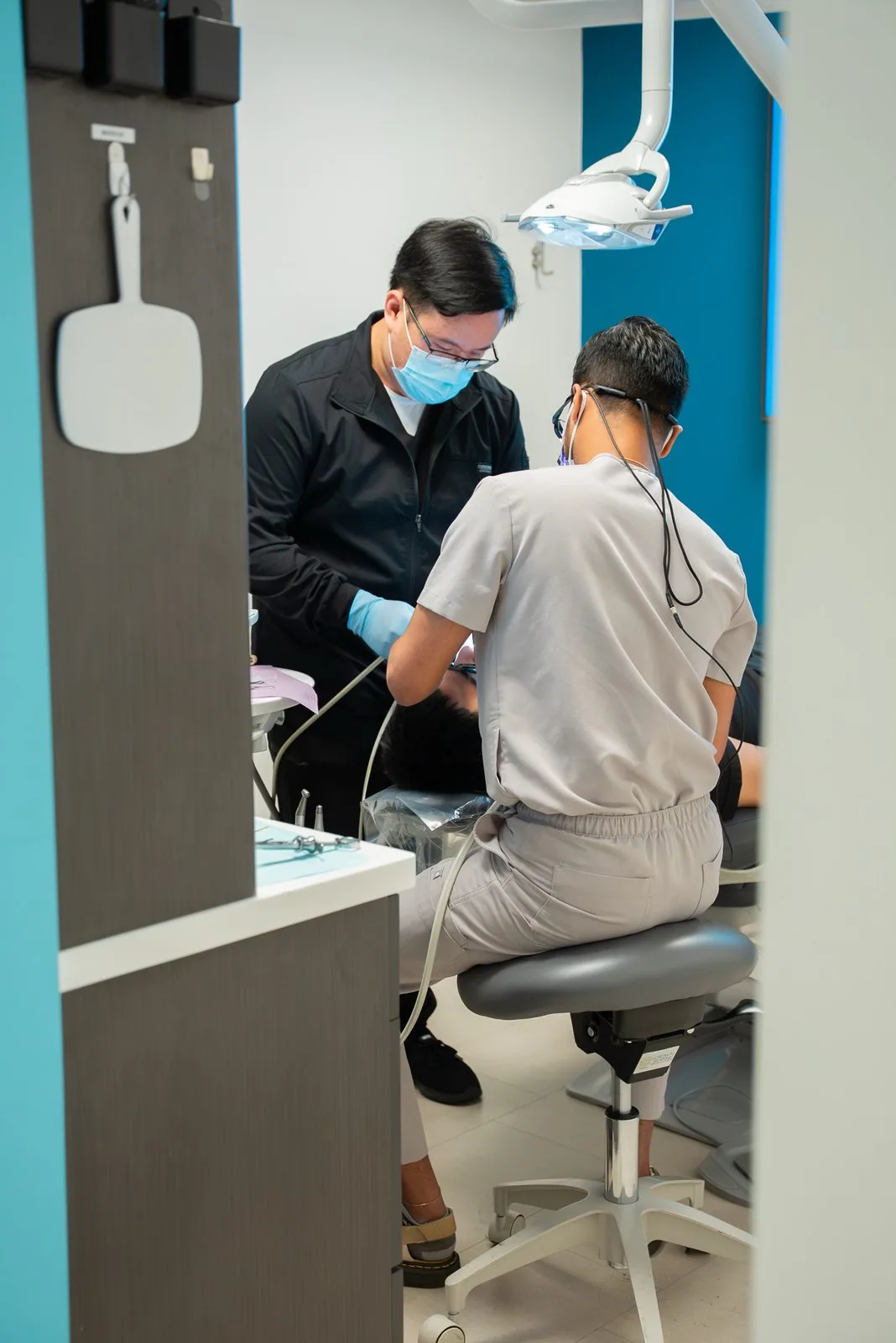 Oasis Dental clinical team consulting with a patient in a treatment room