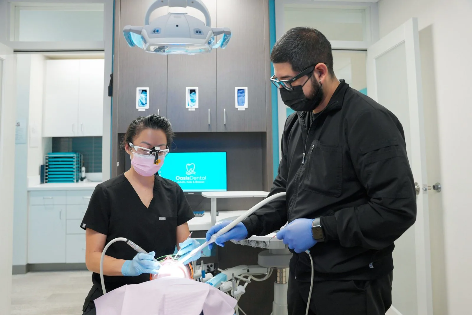 Oasis Dental clinicians preparing for a procedure together