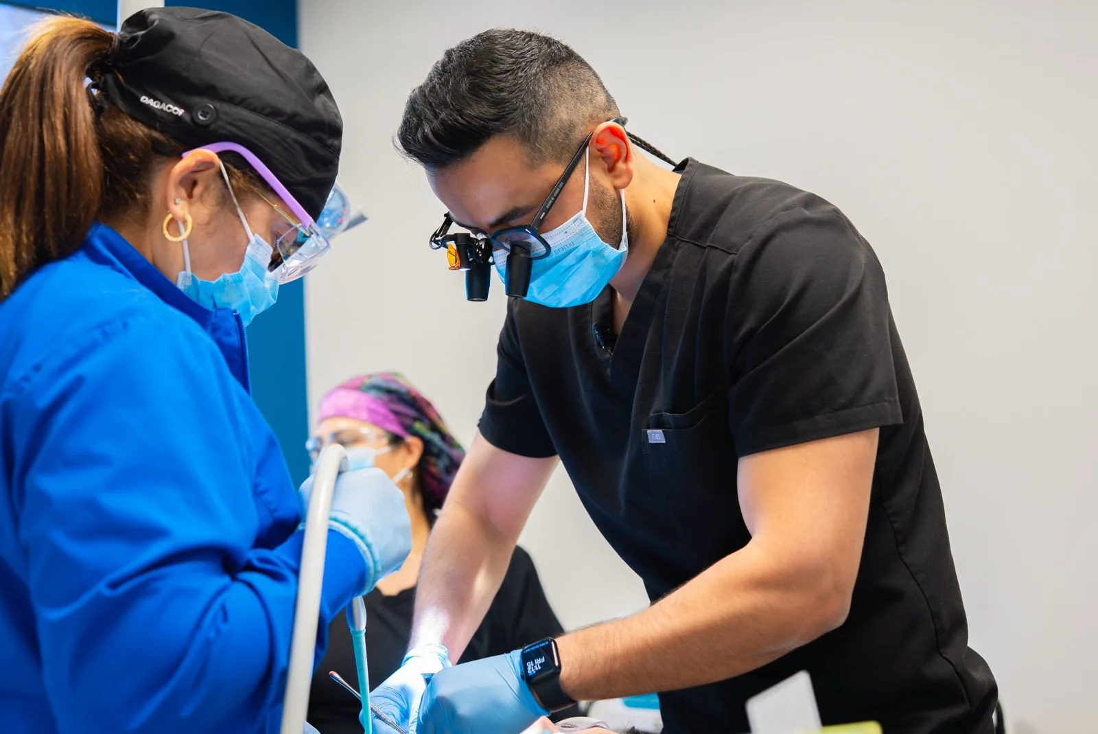 Oasis Dental clinicians performing a procedure together