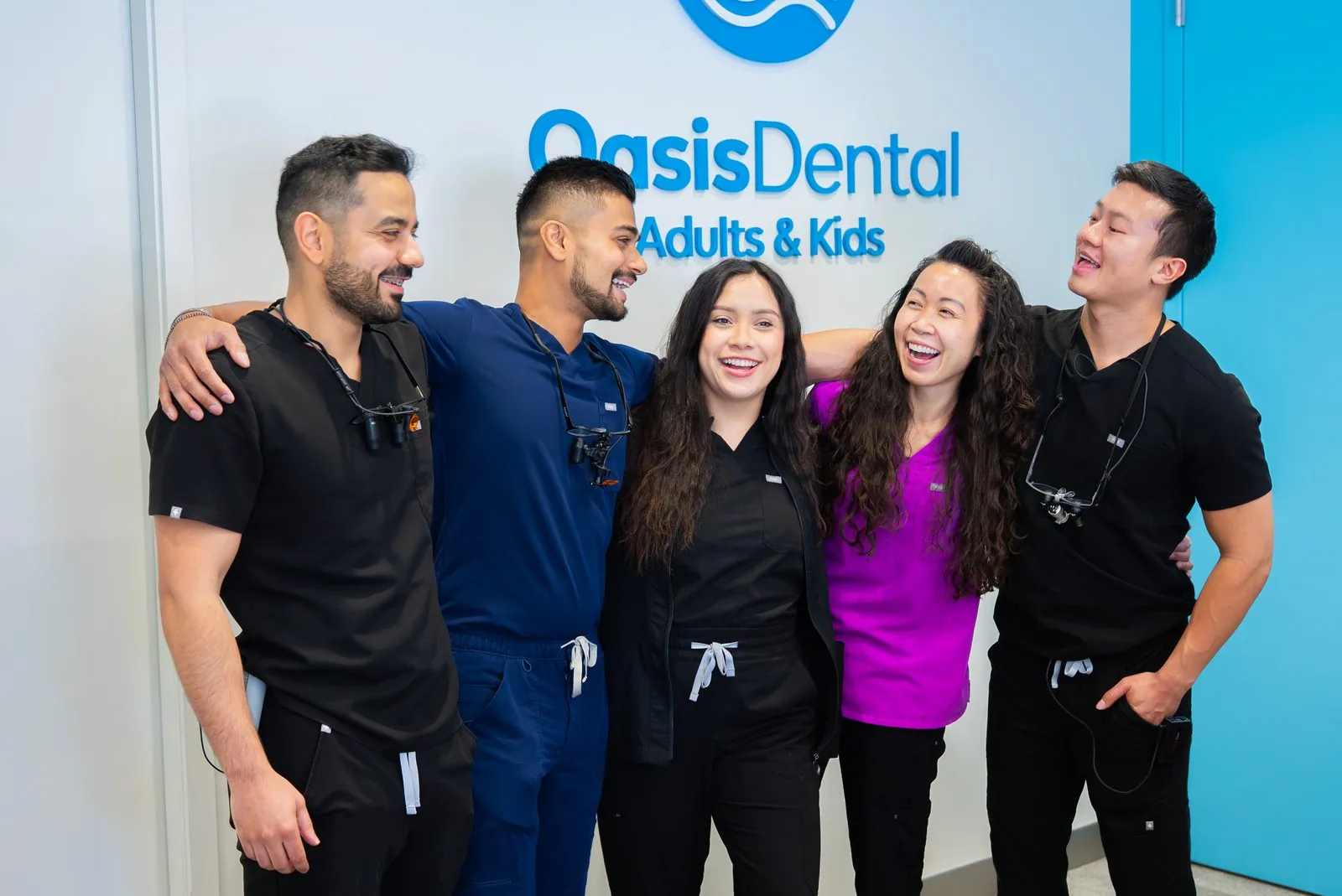 Oasis Dental doctors and team members laughing together at the Aurora office
